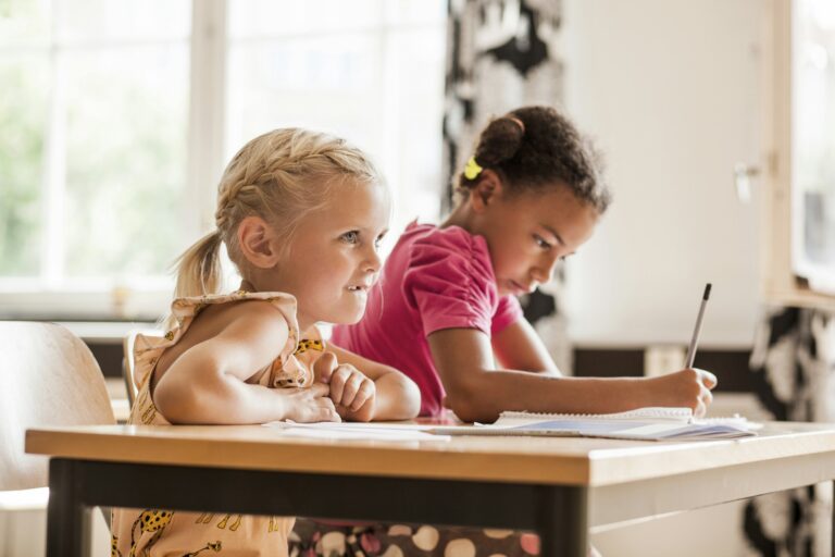 Girls taking notes in classroom