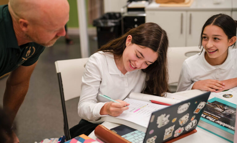 Students working with a teacher during admissions at school
